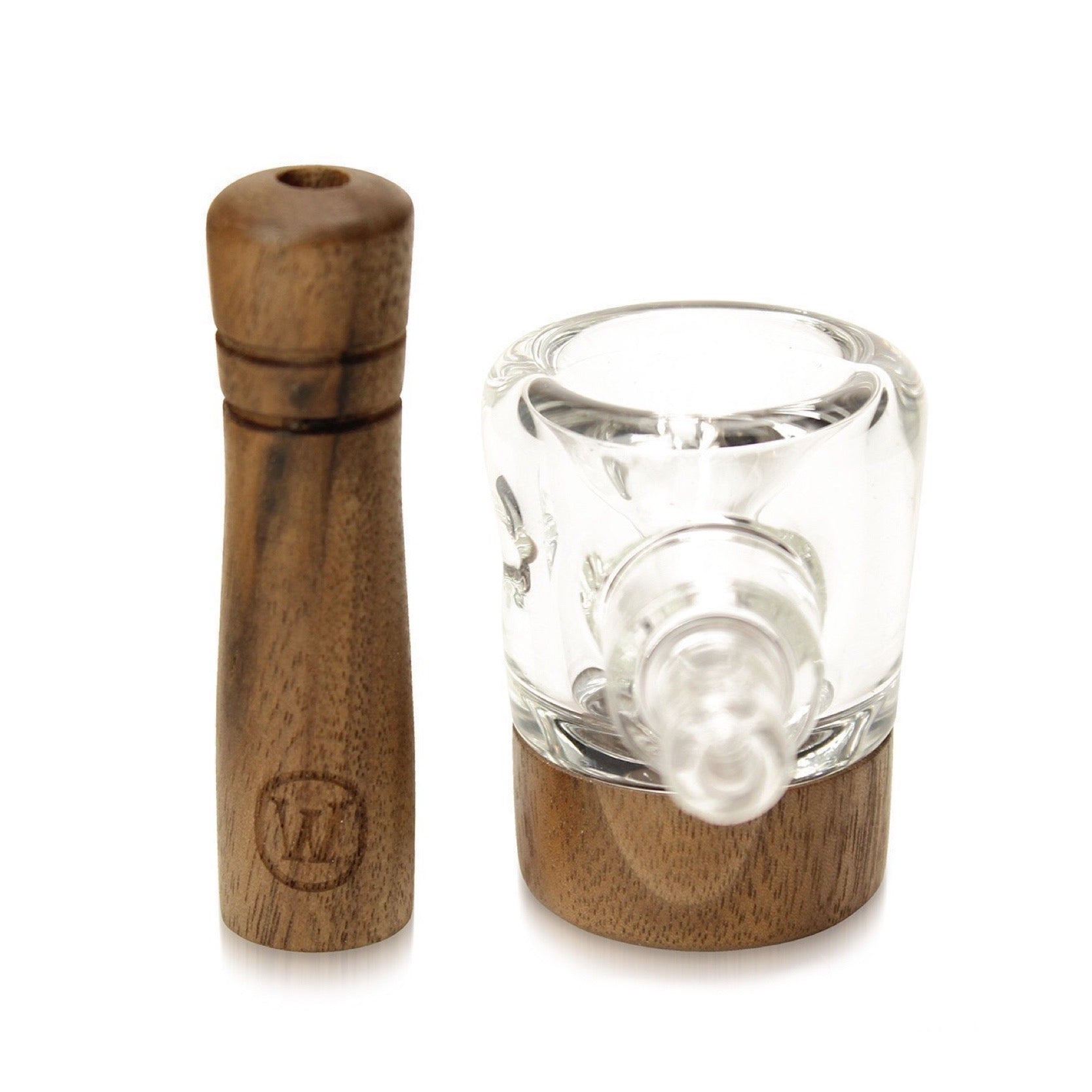 a glass and wooden pepper mill on a white background